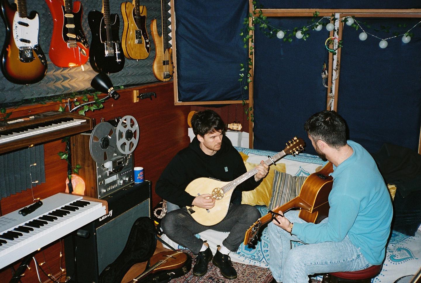Ross McNerney playing bouzouki in a studio, with a bandmate on guitar